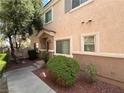 Charming home exterior featuring a covered entryway and meticulous landscaping at 6080 Golden Corral Trl # 103, Henderson, NV 89011