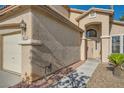 Close-up of the front entrance and side of the 3 car garage, showing the stucco finish at 8447 Amherst Valley St, Las Vegas, NV 89123