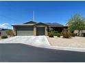 Charming single-story home with a two-car garage, desert landscaping, and solar panels at 8584 Garnet Lake Ave, Las Vegas, NV 89113