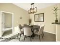 Cozy dining room with a round table, modern light fixture, and neutral decor at 10550 W Alexander Rd # 2103, Las Vegas, NV 89129