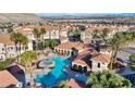 Aerial view of a resort-style pool area with palm trees and comfortable lounge seating at 10550 W Alexander Rd # 2103, Las Vegas, NV 89129