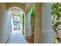 Covered walkway featuring arched columns, offering a charming entrance to the residence at 10235 Headrick Dr, Las Vegas, NV 89166
