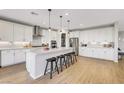 Spacious kitchen with an island, barstools, stainless steel appliances, and ample storage at 10332 Stroma Ave, Las Vegas, NV 89166