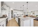 Open-concept kitchen featuring a large island with seating, stainless steel appliances, and plenty of counter space at 10332 Stroma Ave, Las Vegas, NV 89166