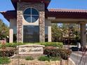 Elegant entrance to The Foothills community with stone accents and manicured landscaping at 10657 San Vercelli Ct, Las Vegas, NV 89141