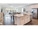 Bright, open kitchen with white cabinets, stainless steel appliances, and a large island at 10806 Space Odyssey Ave, Las Vegas, NV 89129
