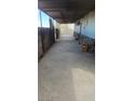 View of a long, concrete driveway, partially covered, and in need of maintenance at 116 Continental Ave, Henderson, NV 89015