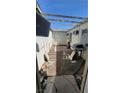 A partially enclosed patio area with a mix of concrete and tiled flooring, needs some work at 116 Continental Ave, Henderson, NV 89015