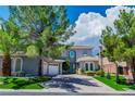 Inviting two-story home featuring drought tolerant landscaping, shade trees, and an attached garage at 133 S Buteo Woods Ln, Las Vegas, NV 89144