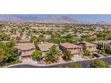 A lovely view of a well-kept neighborhood and desert mountains in the distance at 133 S Buteo Woods Ln, Las Vegas, NV 89144