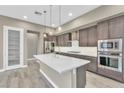 Modern kitchen with stainless steel appliances, white countertops and gray cabinets at 1536 Unison Way # 102, Las Vegas, NV 89135