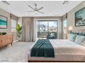 Comfortable main bedroom featuring a ceiling fan, sliding glass door to a balcony, and ample natural light at 1536 Unison Way # 102, Las Vegas, NV 89135