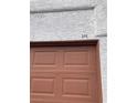 Close-up of the garage door with unit number 213, highlighting the neutral color and paneled design at 1800 Edmond St # 213, Las Vegas, NV 89146