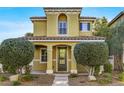 Charming two-story house with a well-kept yard, sidewalk, and a welcoming entrance at 2020 Self Portrait St, Henderson, NV 89044