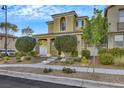 Two-story home with a well-maintained yard, walkway, and inviting entrance at 2020 Self Portrait St, Henderson, NV 89044