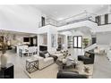 Bright open living room with soaring ceilings, modern decor, and access to the kitchen at 29 Owl Ridge Ct, Las Vegas, NV 89135