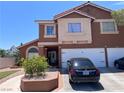Charming two-story home with a three car garage and well-manicured front yard at 2913 Domino Way, Las Vegas, NV 89117