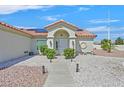 Charming home featuring a covered entrance, desert landscaping, and a warm, inviting facade at 3109 Hawksdale Dr, Las Vegas, NV 89134