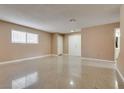 Spacious living room with tile floors, neutral walls, and plenty of natural light at 3350 Duece St, Las Vegas, NV 89121
