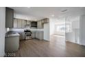 Spacious kitchen with stainless steel appliances, hardwood flooring, and an open layout, ideal for entertaining guests at 3950 Ventura Way, Las Vegas, NV 89121