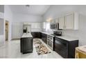 Bright kitchen featuring white upper cabinets, stainless steel appliances, and a kitchen island at 40 Trailside Ct, Henderson, NV 89012