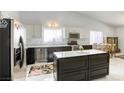 Beautiful kitchen with white cabinets, stainless steel appliances, and a central island with a marble countertop at 40 Trailside Ct, Henderson, NV 89012
