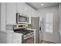 Modern kitchen with stainless steel appliances and white cabinetry at 4855 S Torrey Pines Dr # 101, Las Vegas, NV 89103