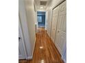 Hallway with hardwood floors, white walls, and access to multiple rooms at 5155 W Tropicana Ave # 2089, Las Vegas, NV 89103