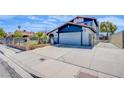 A house featuring a red tile roof, landscaped front yard, and an attached two-car garage at 5301 Kalmia Dr, Las Vegas, NV 89103