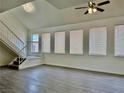 Sunlit living space with large windows, updated flooring, and staircase, creating an inviting atmosphere at 5928 Willard St, Las Vegas, NV 89122
