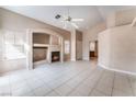 Cozy living room with tile flooring, fireplace and built-in shelving at 6149 Elderberry Wine Ave, Las Vegas, NV 89142