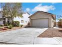 Attractive one-story house with a spacious driveway, two-car garage, and low-maintenance landscaping at 6314 Shadow Moon Pl, North Las Vegas, NV 89031