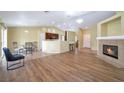 Open-concept living area featuring wood floors, a cozy fireplace, and seamlessly connects to the kitchen at 635 Dry Valley Ave, North Las Vegas, NV 89031