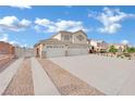Wide driveway leads to a home with a three-car garage at 6927 Adobe Villa Ave, Las Vegas, NV 89142