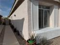 Home exterior showing stucco, white trim, and window with white shutters at 7062 Russell Ranch Ave, Las Vegas, NV 89113