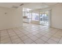 Bright living room featuring tile flooring, sliding glass doors and views to the kitchen and backyard at 7176 Fenway Ave, Las Vegas, NV 89147