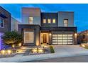 Contemporary home exterior with a glass-panel garage door, modern landscaping, and inviting front entrance at 746 Horizon Canyon Dr, Henderson, NV 89052