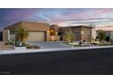 Beautiful front exterior showcasing a landscaped yard, brick driveway, and built-in garage at 818 Laceleaf St, Las Vegas, NV 89138
