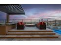 Outdoor patio featuring tile flooring, comfy seating, and outdoor kitchen at 818 Laceleaf St, Las Vegas, NV 89138