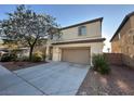Two-story home with an attached garage and neutral-toned stucco exterior, showcasing curb appeal at 8205 Celina Hills St, Las Vegas, NV 89131