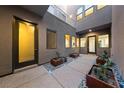 Inviting courtyard featuring a decorative walkway, elegant planters, and a well-lit entrance at 845 Loch Katrine Ave, Henderson, NV 89012