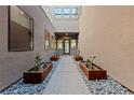 Inviting courtyard featuring a decorative walkway, elegant planters, and a well-lit entrance at 845 Loch Katrine Ave, Henderson, NV 89012