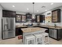 Modern kitchen with granite countertops, stainless steel appliances, and a central island with seating at 9113 Sea Mink Ave, Las Vegas, NV 89149