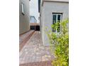 Long driveway on side of house with pavers leading to backyard gate at 10077 Cooper Mountain St, Las Vegas, NV 89141