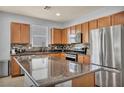 Modern kitchen boasts stainless steel appliances, including a large refrigerator, and an island with a granite countertop at 1152 Pine Cove Ct, Henderson, NV 89011