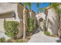 Close-up of the home's stucco exterior, showing the private gated entrance and desert landscaping at 11540 Snow Creek Ave, Las Vegas, NV 89135