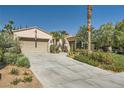 Inviting single-story home with a spacious driveway, desert landscaping, and an attached two-car garage at 11540 Snow Creek Ave, Las Vegas, NV 89135