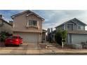 Charming two-story homes with well-maintained exteriors, driveways, and attached garages at 1653 Crystal Shadows Cir, Las Vegas, NV 89119