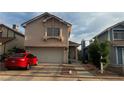 Charming two-story homes with well-maintained exteriors, driveways, and attached garages at 1653 Crystal Shadows Cir, Las Vegas, NV 89119