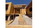 Exterior view of a new construction home featuring a sloped yard and a wooden staircase at 1764 Amarone Way, Henderson, NV 89012